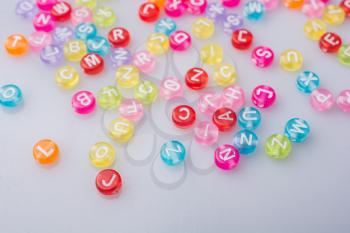 Multi color alphabet letter beads scattered randomly