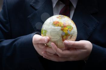Businessman is standing with an earth globe fot business concept