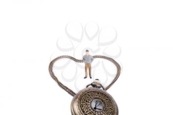Retro styled pocket watch and its chain form a heart and a little figurine stands in it
