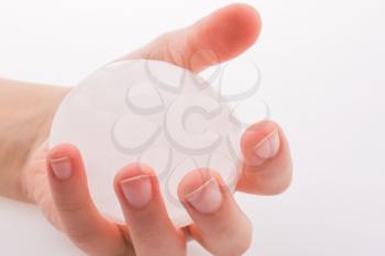 Hand holding an ice ball on a white background