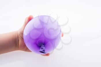 Hand holding a Colorful small balloon on a white background