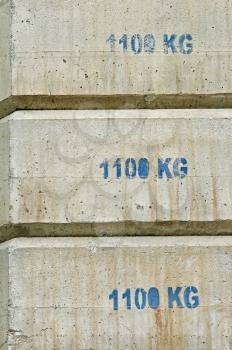 Concrete counterweight blocks used in building construction.