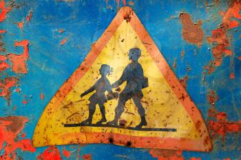 Rusty traffic control warning sign for school children. Speed restriction.