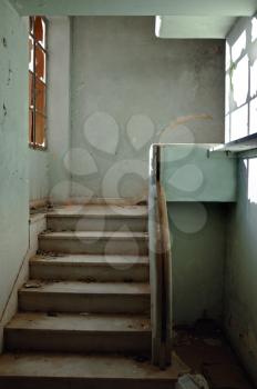 Dirty staircase and peeling walls. Abandoned building interior.