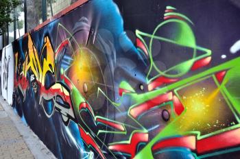 Wall surface covered with colorful graffiti. Urban street art.