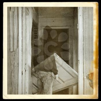 Vintage burned photograph of ghost in haunted hallways of an abandoned house.