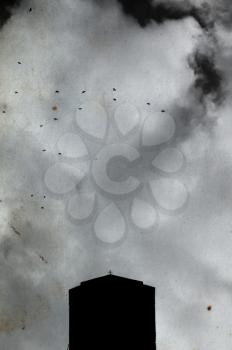 Church cross silhouette, overcast sky and flying birds on stained grungy paper. Orthodox monastery at Meteora, Greece.