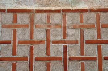 Cross pattern on old church wall exterior. Abstract background.