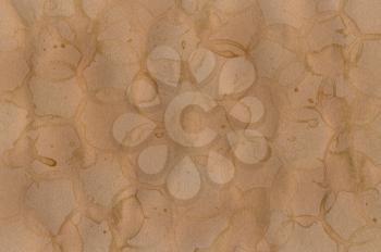 Coffee stains on brown paper background texture. Abstract pattern.