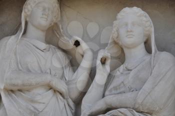Stele of Demetria and Pamphile funerary sculpture in memory of two dead sisters depicted gazing apathetically and grasping their veils. Ancient cemetery of Kerameikos, Athens Greece.