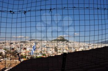 The city of Athens, Greece viewed through fence grid squares background.