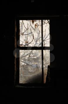 Dusty window frame in dark room of an abandoned house.