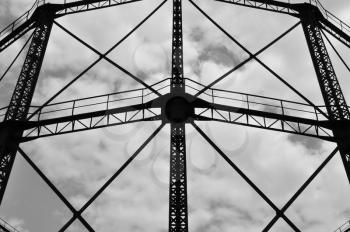 Industrial gasholder frame iron structure exterior abstract architecture. Black and white.