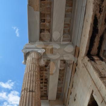 Ionic column and marble ceiling ancient architecture detail. Acropolis Propylea, Athens Greece.
