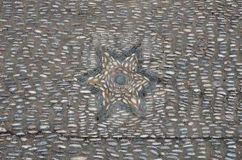 Pebble mosaic with star pattern abstract background.
