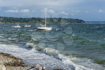 Boats bob on choppy water in the Puget Sound. Location is Normandy Park, Washington.