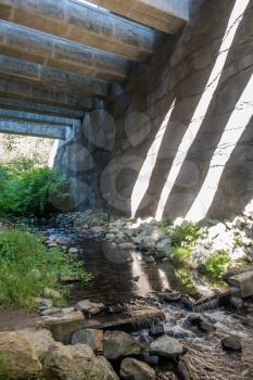 Support structure casts shadows onto a wall at the Des Moines Creek Trail in Washington State.