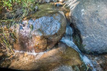 Water flows between rock at Coulon Park in Renton, Washington.