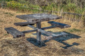 HDR image of a wetherbeaten picnic table.