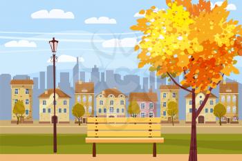 Autumn city park at sunset. Wooden bench, vintage street lights, colorful trees, defoliation, city buildings, setting sun,