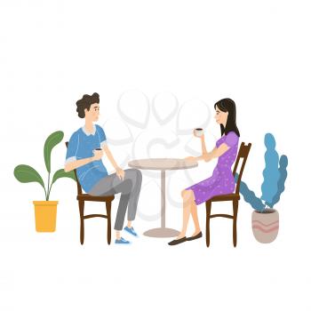 Cute couple sitting at table, drinking tea or coffee and talking in open air cafe