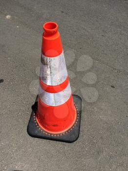 Traffic safety cone on road background on hot day