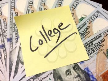 Post it note with handwritten text college on money aerial view