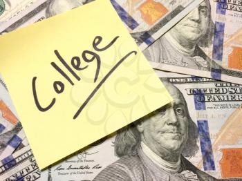 Post it note with hardwritten college on money straight on view with text space on right