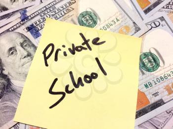American cash money and yellow sticky note with text Private school in black color aerial view