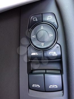 Automatic Window and mirror buttons in car made of black plastic
