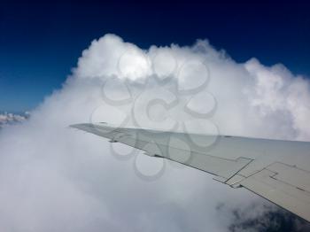 Blue sky and white clouds from airplane window