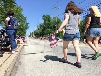 girls at july 4 parade with american flag