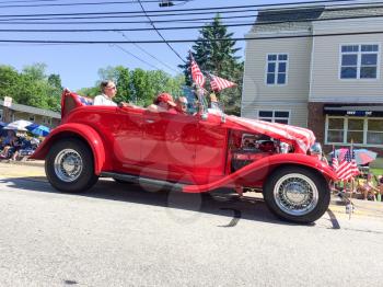 old cars at july 4 parade going down main street