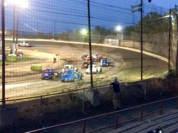 dirt track racing speedway at night spectators watching