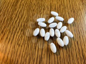 white oval pills medicine on background with copy text space