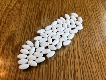 white oval pills medicine on background with copy text space