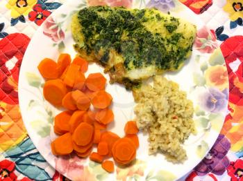 carrots rice and quiche served on a floral plate background