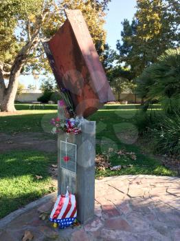 911 9-11 september terrorist attack memorial steel gurder and flag of deflated balloon and dead flowers concept