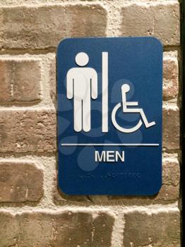 Men restroom blue white sign handicapped pictogram symbol on brick wall