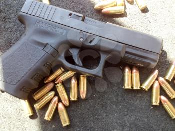 Bullets 9mm 40 caliber close up with Glock handgun firearm pistol