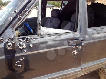 Automobile shot up bullet gun fire fight holes