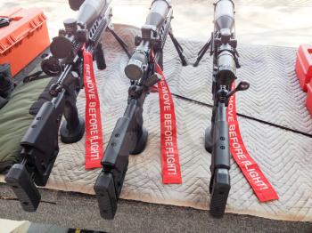 Military assualt weapon sniper rifle multiple lined up on display