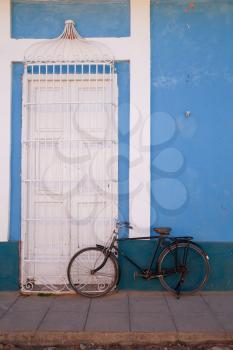 Trinidad, Cuba - 2 February 2015: Vintage bicycle and colonial architecture