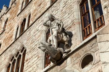 Leon, Spain - 9 December 2019: Saint George killing dragon statue above the entrance to Casa Botines