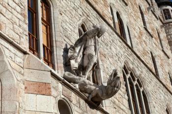 Leon, Spain - 9 December 2019: Saint George killing dragon statue above the entrance to Casa Botines