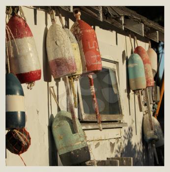 Old buoys on a wall on a shack in Maine, USA.  Cross processed to look like and instant picture.