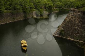 Golden boat on a river around Osaka castle in Japan