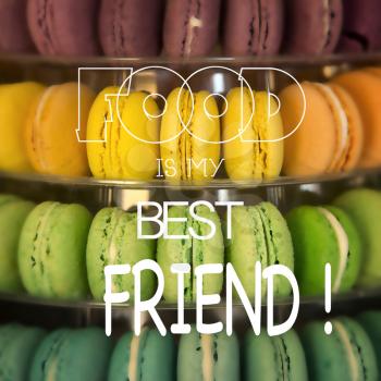 inspirational quote Food is my best friend on picture with colourful macarons