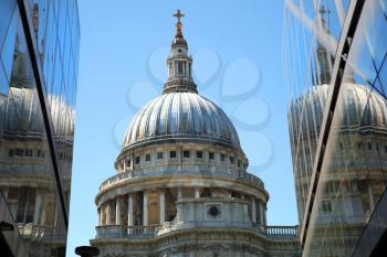 St-Paul's Cathedral and reflection in a mirror wall with a blue sky with no clouds