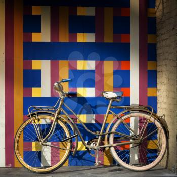 Vintage bicycle on a wall full of geometric pattern